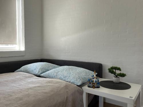 a bedroom with a bed and a table with a toy truck at The Heart of Billund apartment by KIRIJA in Billund