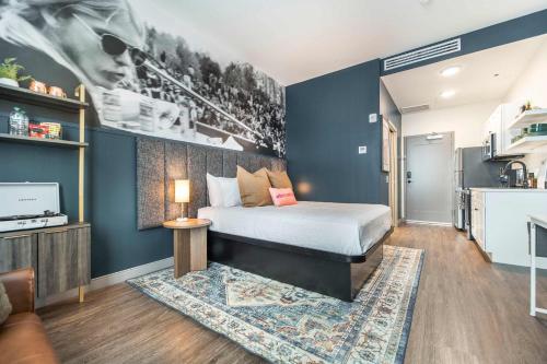 a bedroom with a bed and a kitchen at Chill Like Gregg Sunlit Southern Vibe in Macon