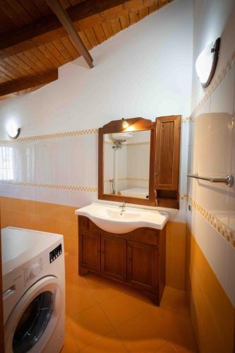 a bathroom with a washing machine and a sink at Sunshine Apartments in Trappeto