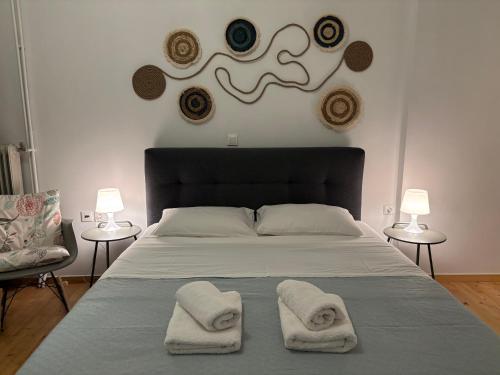 a bedroom with a bed with two towels on it at Simple and Relaxing House! in Kalamata
