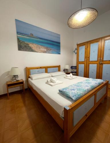 a bedroom with a large bed with white sheets at Casa Betta in Stintino
