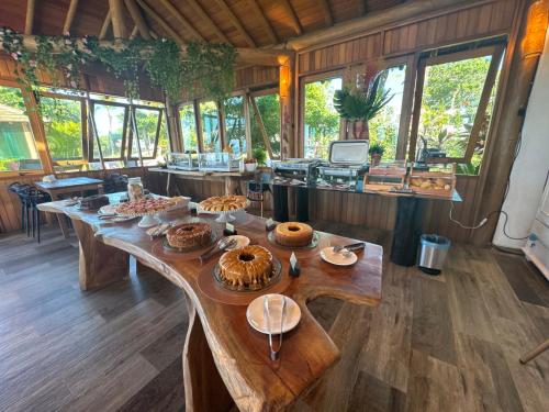 a room with a table with food on it at Village Muta in Porto Seguro