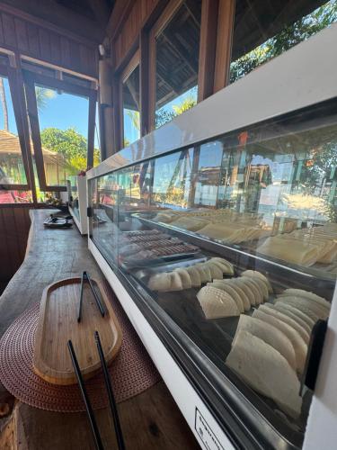 a bakery with a display case filled with bread at Village Muta in Porto Seguro