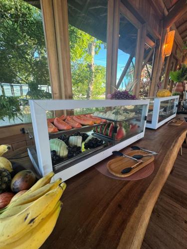 a display of fruits and vegetables on a table at Village Muta in Porto Seguro