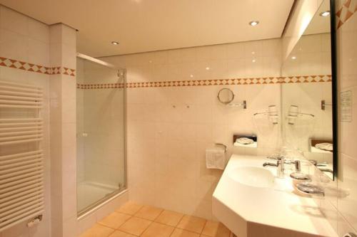a bathroom with a sink and a shower at Naturparkhotel Adler in Wolfach