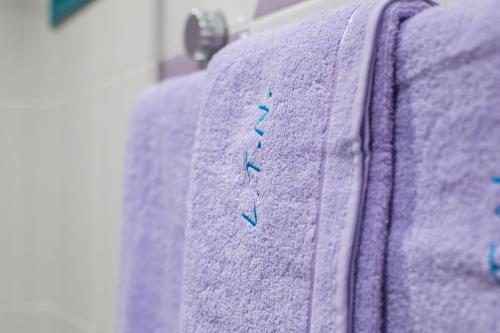 a purple sweater with blue embroidery on it at La Terra Nostra in Korinthos