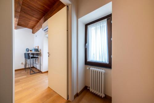 an open door to a room with a window at Suite Deluxe in Palazzo Storico - Centro Sassari - Appartamento Calvi in Sassari