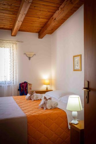 a bedroom with a bed with towels on it at Sunshine Apartments in Trappeto