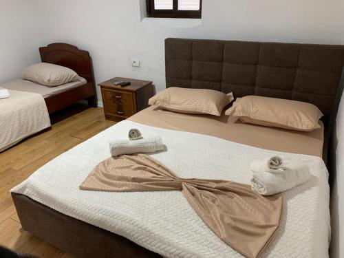 a bedroom with two beds with towels on them at Guesthouse N&B in Berat