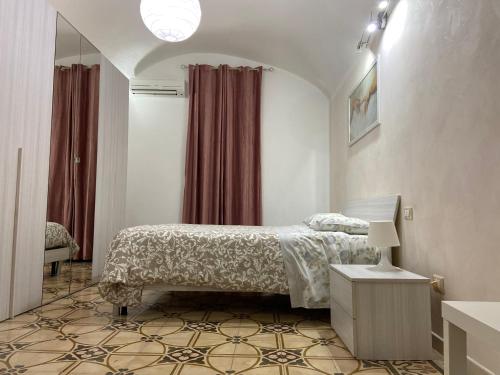 a bedroom with a bed and a table with a lamp at Sea Home in Monopoli