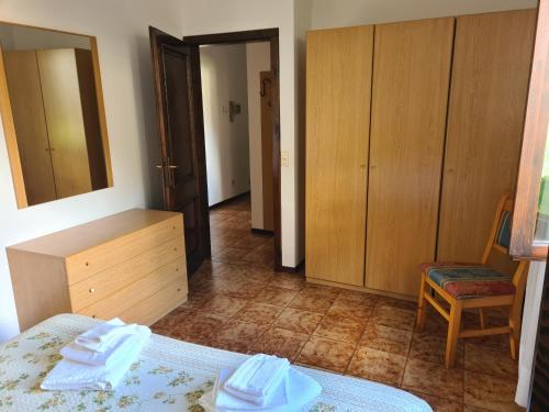 a bedroom with a bed and a dresser and a mirror at Bioledro - Casa Lena in Mezzolago
