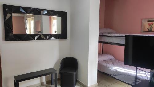 a room with a mirror and bunk beds at Bed and Breakfast Oasi in Reggio Calabria