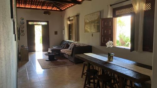 a living room with a table and a couch at Village por do sol in Aracaju