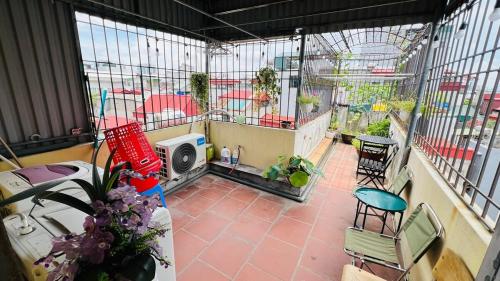 an indoor balcony with a bird cage with plants at Studio Kéo lưới in Hanoi