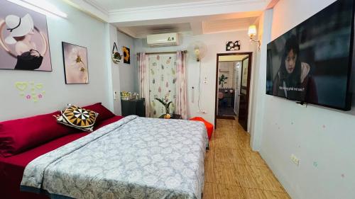 a bedroom with a bed and a flat screen tv at Studio Kéo lưới in Hanoi