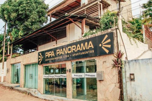 a building with a sign on the side of it at Pipa Panorama Aparthotel in Pipa