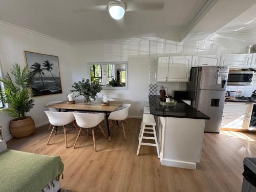 a kitchen and living room with a table and chairs at Tides End in Ballito