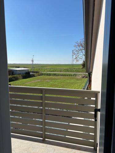 a balcony with a view of a field at Sunset INN in Scardovari