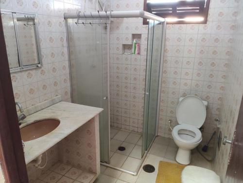 a bathroom with a shower and a toilet and a sink at Village por do sol in Aracaju