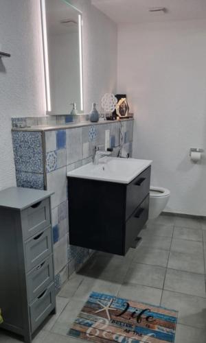 a bathroom with a sink and a toilet at Vacation home Moselsteg in Brauneberg