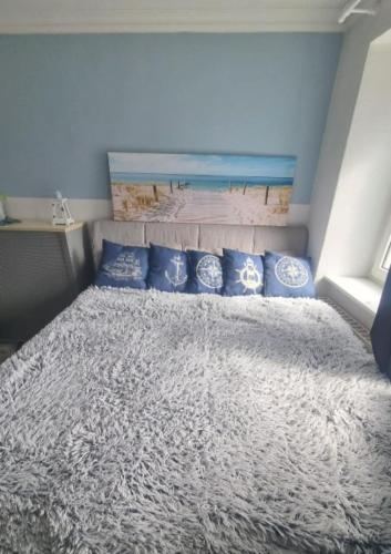 a bedroom with a large bed with blue pillows at Vacation home Moselsteg in Brauneberg