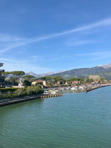a river with a town and mountains in the background at Relax between the sea and the mountains in Cinquale