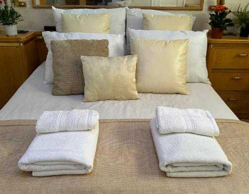 a bed with two towels sitting on top of it at Exclusive Yacht Stay - Best Sea & Old Town Views - Prime Location in Kavala