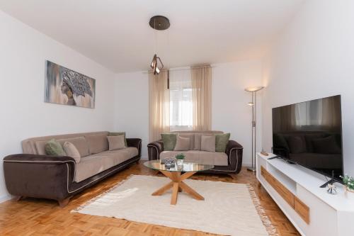 a living room with a couch and a tv at Apartman Klara in Imotski