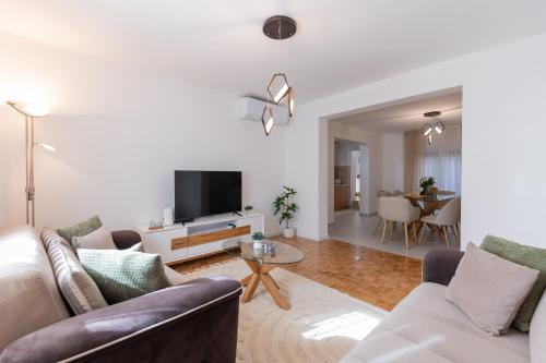 a living room with a couch and a tv at Apartman Klara in Imotski