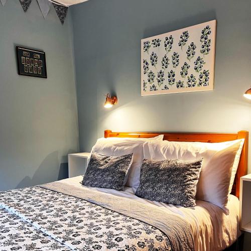 a bedroom with a bed with two pillows on it at Chapter Cottage, Cheddleton Nr Alton Towers, Peak District, Foxtail Barns, the Ashes in Cheddleton