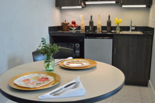 a kitchen with a table with two plates on it at Hotel Audubon in Sainte Genevieve