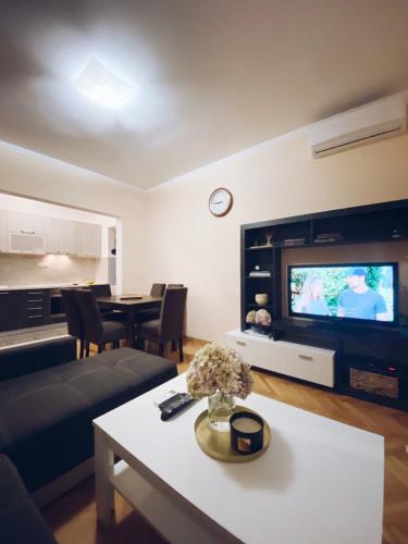 a living room with a couch and a table at Apartmani Vucetic MM in Igalo