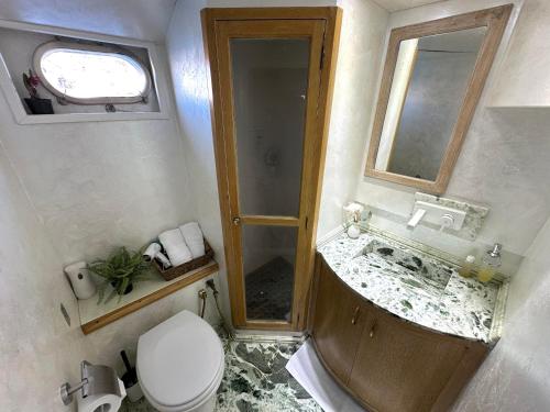 a small bathroom with a toilet and a sink at Exclusive Yacht Stay - Best Sea & Old Town Views - Prime Location in Kavala