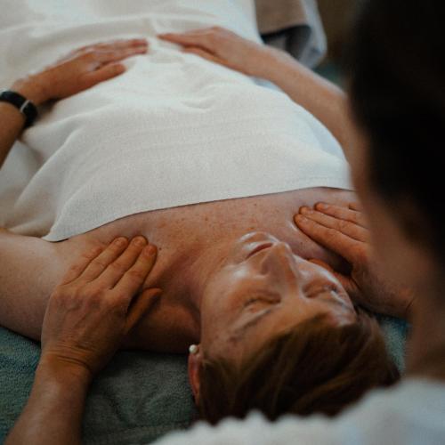 a woman laying on a bed with a mans face at Apart Bieles NEU - Bergoase mit privater Outdoor-Sauna & Massagepraxis in Kauns