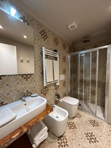 a bathroom with a sink and a toilet at Hotel Ariston & Apartments in Varazze