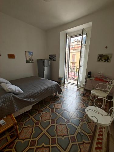 a bedroom with a bed and two stools in it at Casa San Rocco in Fondi