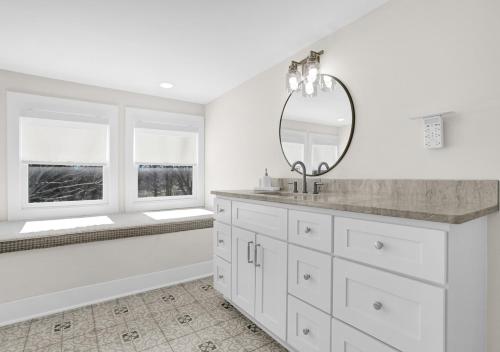 a bathroom with a tub and a sink and a mirror at Walk to Memphis Nightlife, 100 Yr Old Cozy Apt in Memphis