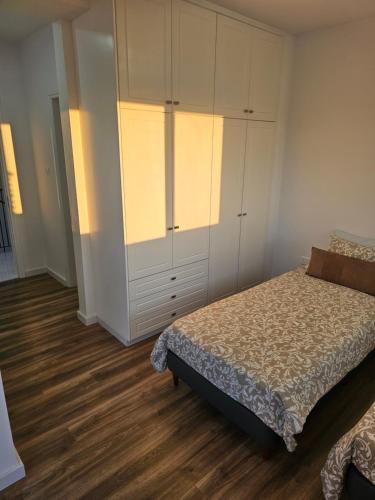 a bedroom with a bed and a large cabinet at Villa Enalia Paphos in Paphos City