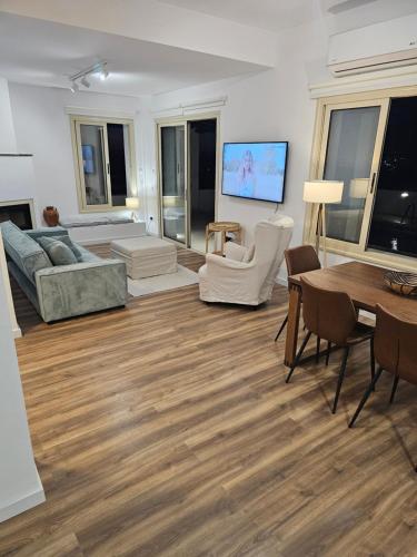a living room with a couch and a table at Villa Enalia Paphos in Paphos City