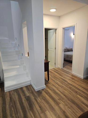 an empty living room with stairs and a bedroom at Villa Enalia Paphos in Paphos City