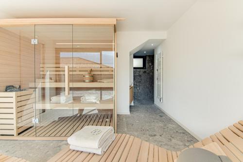a room with a bed and a glass wall at VILLA ULIVI by Curti affitti in Tremezzo