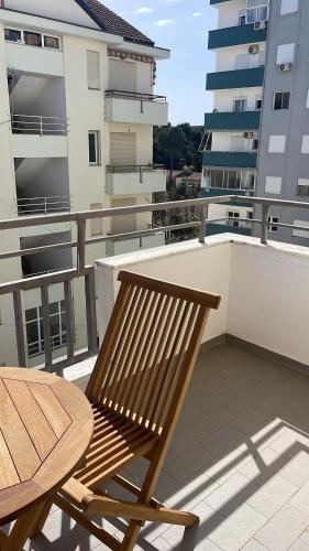 a wooden bench sitting on top of a balcony at Adriatic Bliss in Golem beach in Golem
