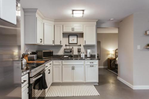 a kitchen with white cabinets and a stove top oven at 1Br 1bath - Greenway Garage w Firepit in Athens