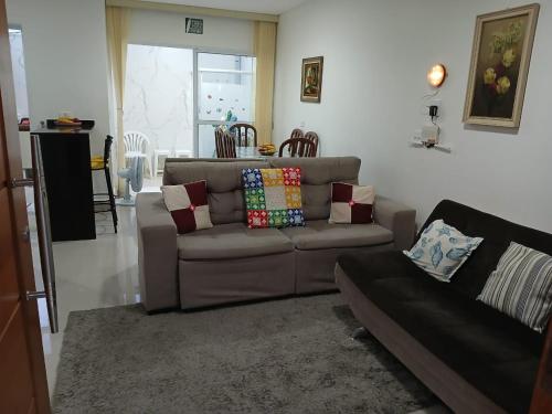 a living room with a couch and a table at sobrado 08 com duas suítes, conf in Guarujá