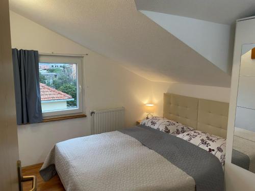 a bedroom with a bed and a window at Villa Korčula in Vela Luka