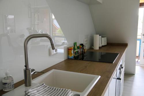 a kitchen with a sink and a counter top at Ferienwohnung Herzmuschel in Varel