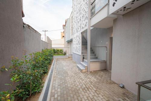 a courtyard of a building with stairs and plants at Elymara Family Vacation Home in Nikiti