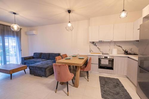 a kitchen and living room with a table and a couch at Elymara Family Vacation Home in Nikiti