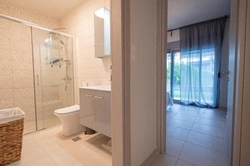a bathroom with a toilet and a sink and a shower at Elymara Family Vacation Home in Nikiti