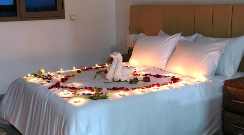 a white bed with lights and a stuffed animal on it at Appartement lux dakhla in Dakhla